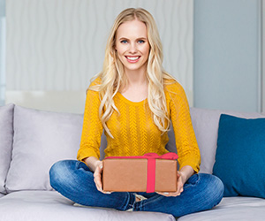 woman sitting and holding present