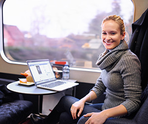 woman on train with computer