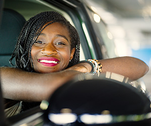 woman in car smiling