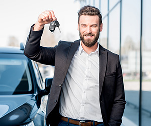 man holding up car keys